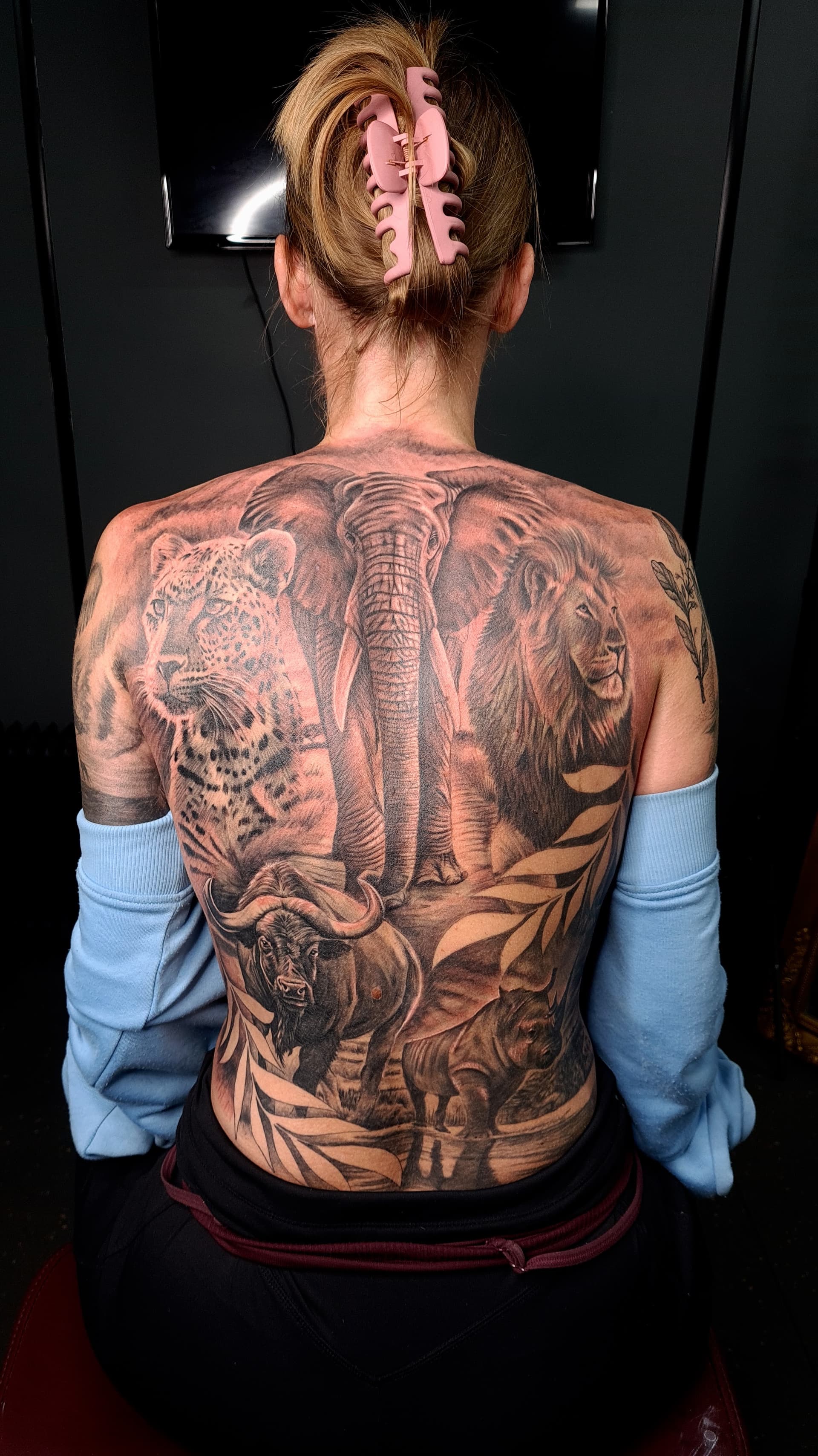 Black and grey realism tattoo of an elephant, lion, leopard, buffalo and rhino covering the full back