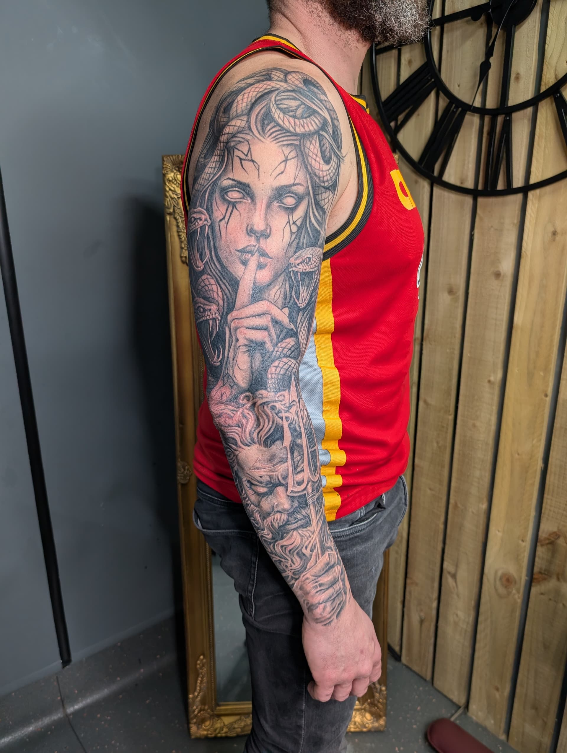 Black and grey realism tattoo sleeve featuring Medusa and Poseidon covering the full arm
