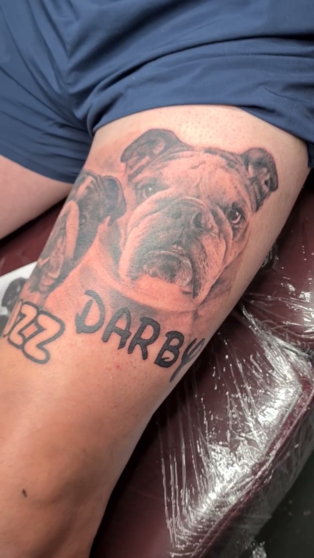 Two bulldog portraits thigh tattoo, the finished piece — cover photo